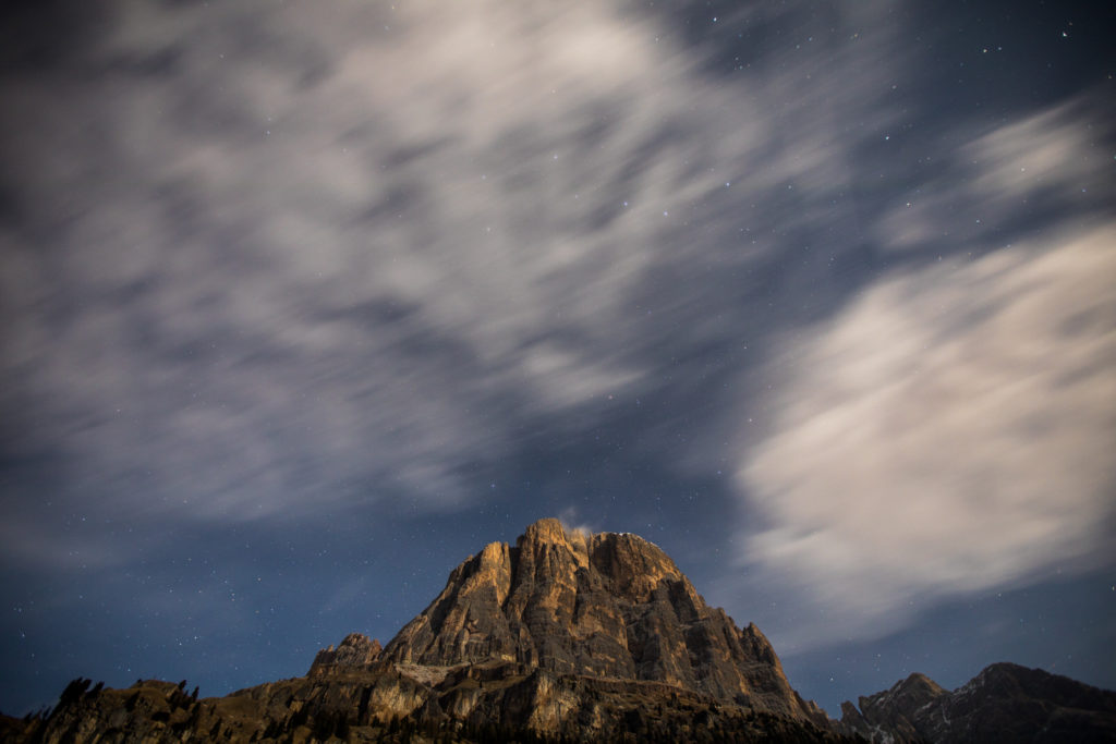 Clouds sweeping above a sunlit granite peak