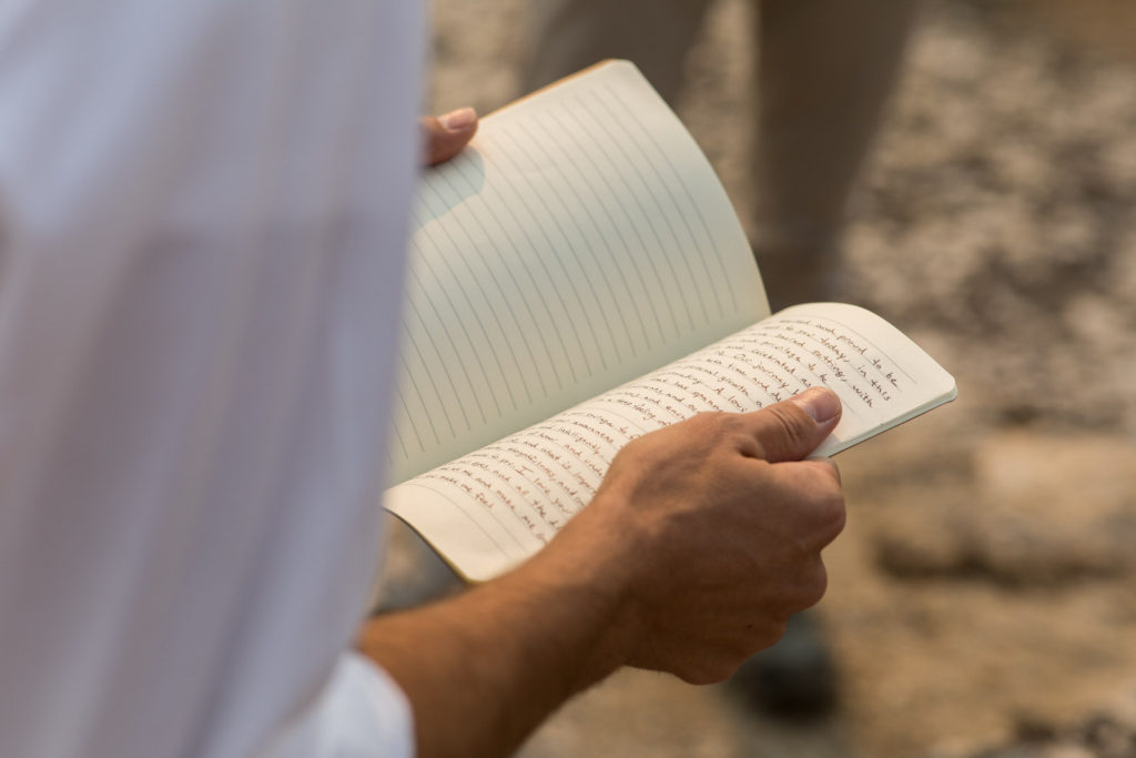 Close-up of handwritten wedding vows in a notebook