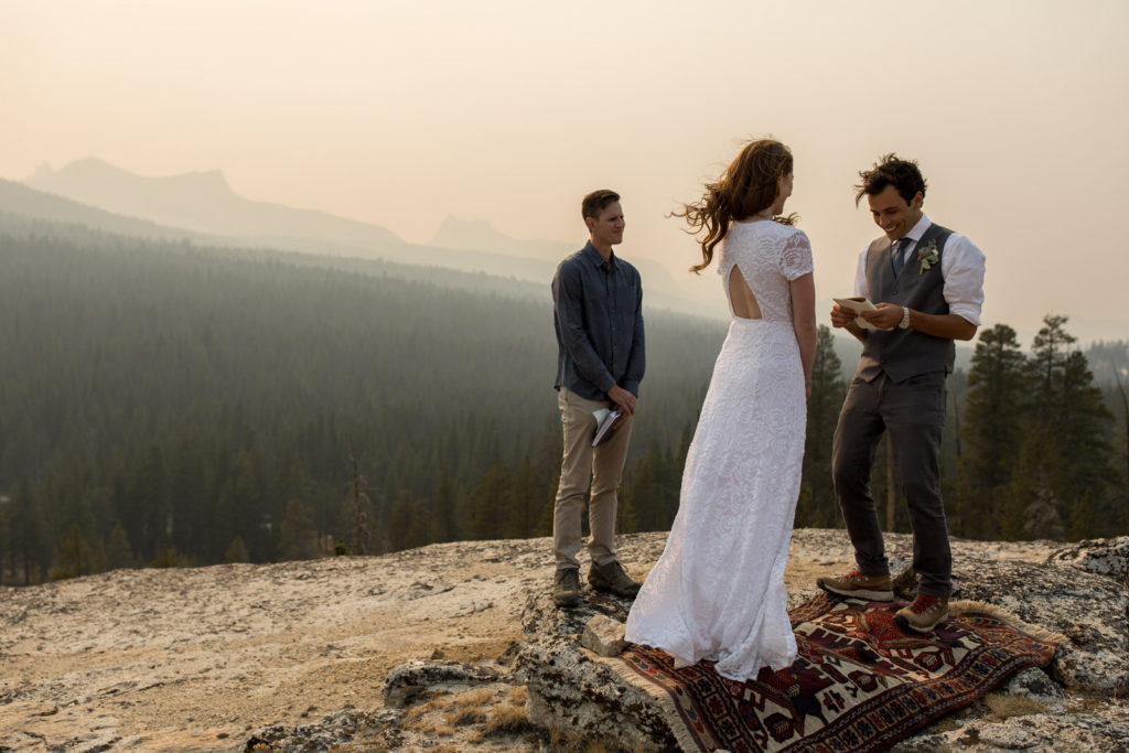 Officiant standing with the couple during an intimate overlook ceremony