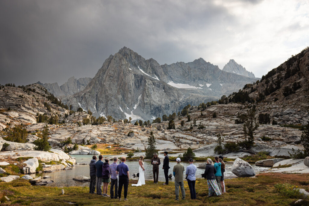 Guests gathered for an intimate ceremony beside a lake in Sabrina Basin