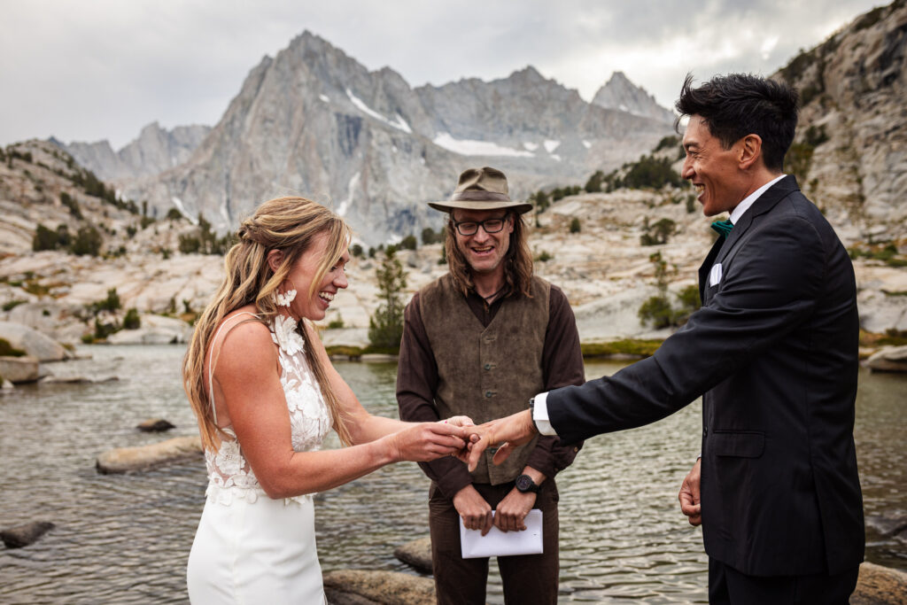 Couple exchanging rings during their mountain ceremony