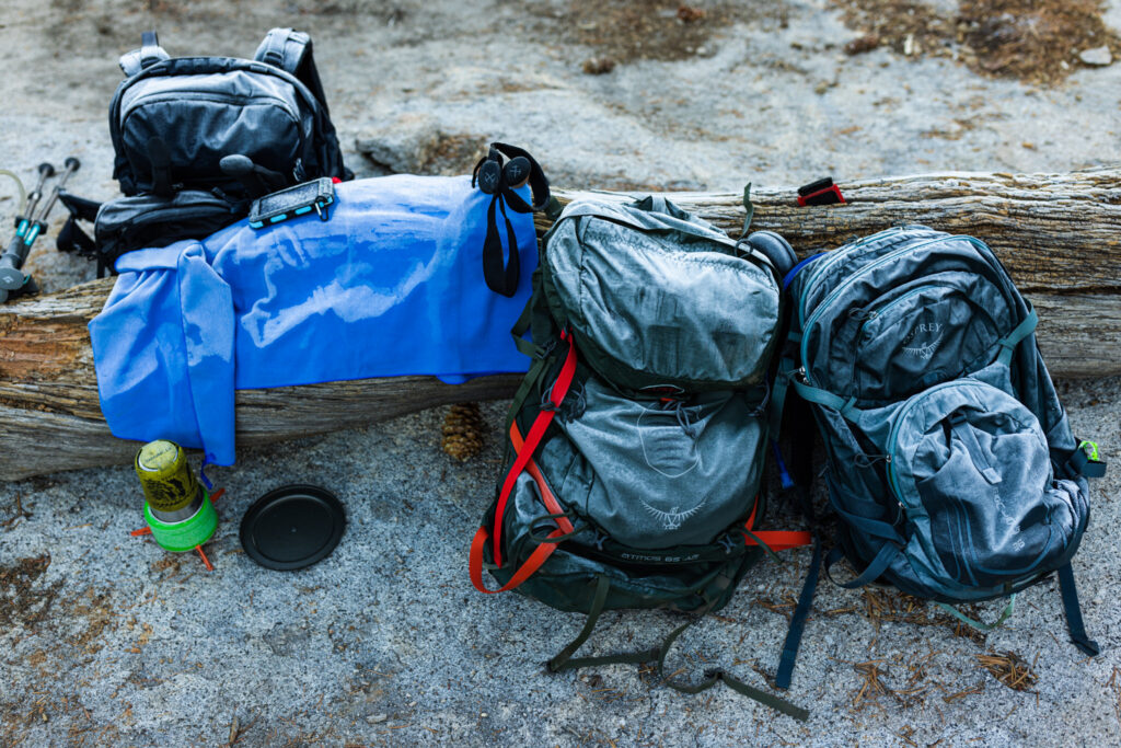 Backpacks and hiking equipment resting on granite