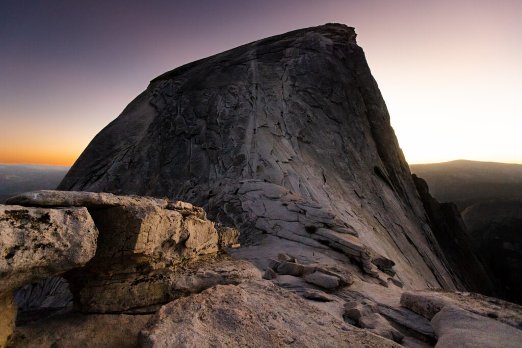 Steep granite dome silhouetted against the evening sky