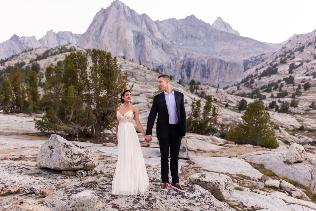 Wide portrait of the wedding couple on a rocky mountain plateau
