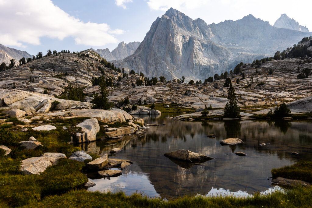Granite mountain peaks reflected in a calm alpine lake