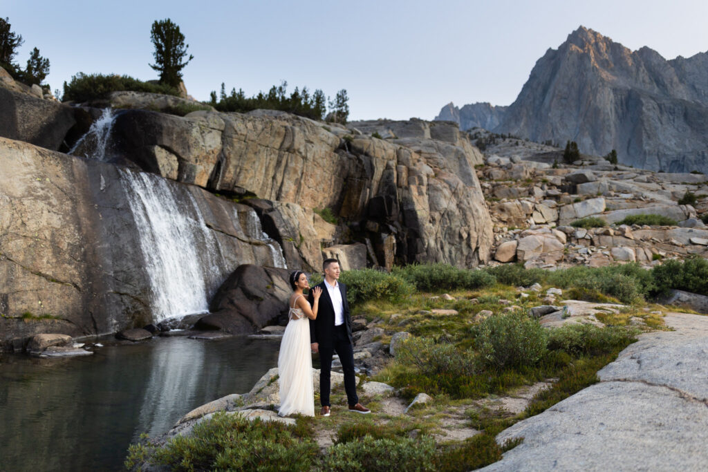 Wedding couple beside a waterfall and granite pool